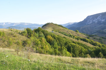 Naklejka premium Green hills in mountain valley. spring landscape