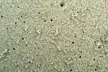 Sea shore sand, colored beach sand. The crack on the sand.
