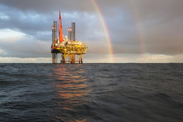 Offshore Jack Up Rig in The Middle of The Sea at Sunset Time