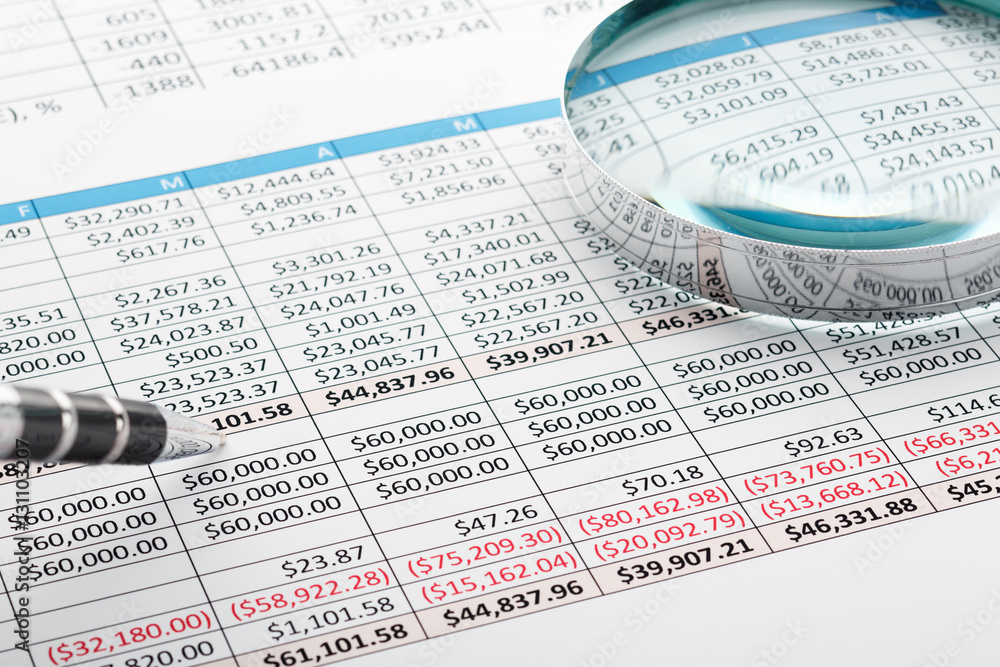 Wall mural Close up of finance business sheet with pen and  magnifying glass