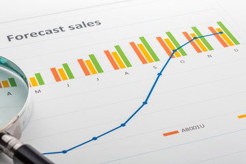 Naklejka premium Close up of finance business sheet with magnifying glass