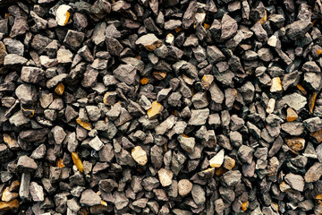 stone wall - construction aggregate, coarse dark gray loose stones. Rough gravel / grit crushed at a stone pit.