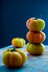 Close up of heirloom tomatoes over a blu rusty background