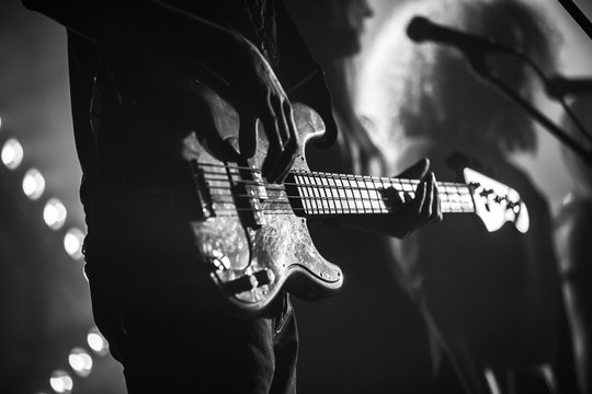 Electric bass guitar player, monochrome