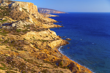 Obraz premium Beautiful seascape. Red beach on the island of Crete. A mountain range stretches along the Libyan Sea.