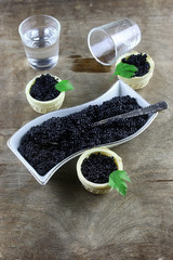 black caviar on a wooden background