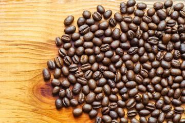 Organic roasted coffee beans on wood texture background