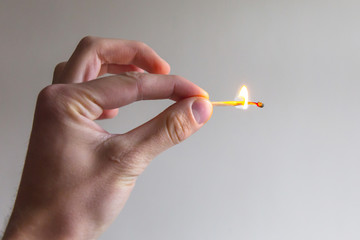 man hand gesture with fire match