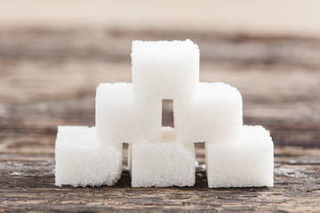 Sugar cube on the wooden background