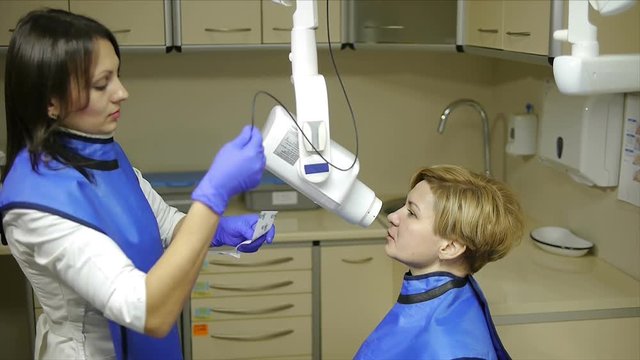 Dentist take jaw x-ray of female patient