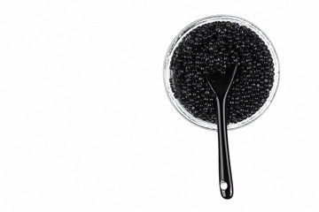 Black caviar in a glass, isolated white background, close up, top view