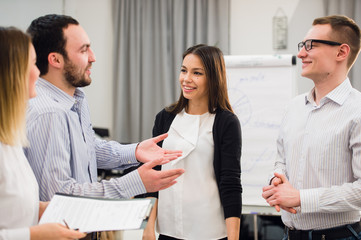 Happy attractive business group standing in an office