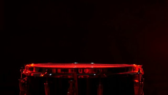 Close up of drums perfused with water for special effect, red backgrounds
