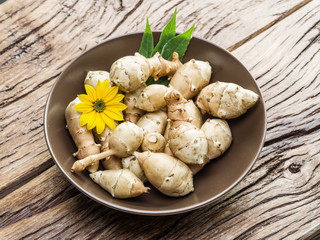 Jerusalem artichoke on wooden table.
