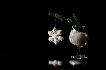 Christmas and New Year`s snow decorations on a black mirror refl