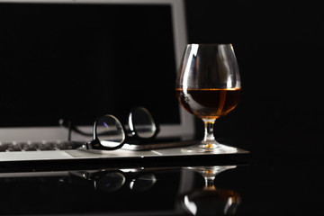 Snifter with brandy on a reflective background
