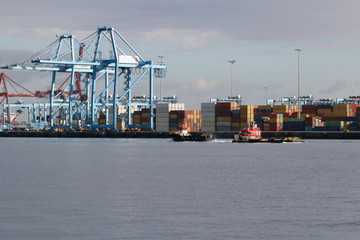 Two tug boats in the harbor.