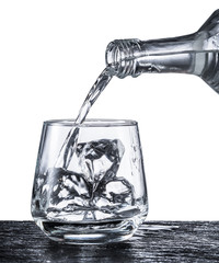 Pouring alcohol into a glass.