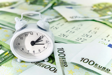 The clock on the background of the euro