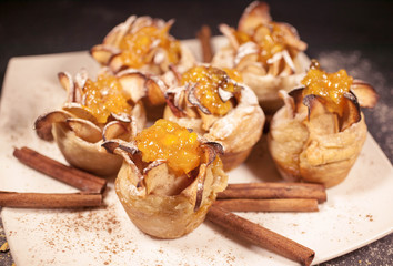Dessert with apples, cinnamon and lemon jam. Food composition on a dark background