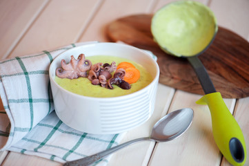 Cream soup with octopus and vegetables