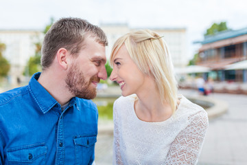 happy couple press nose together