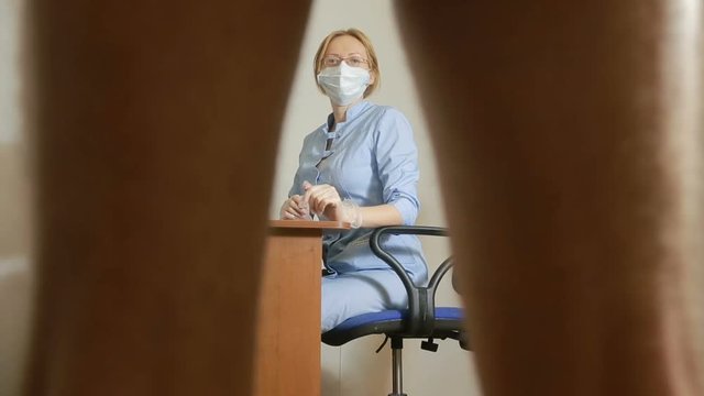 a man is examined by a doctor of the urologist. woman doctor. inspects