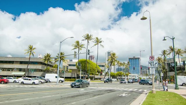 Honolulu Hawaii Busy Downtown City Intersection with Vehicle Traffic Cars Passing on Street with Buildings in Background