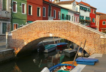 old brick bridge over the navigable channel island of Burano in