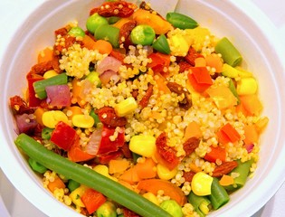 dish of boiled mixed vegetables and seeds of quinoa