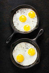 Pans with fried eggs