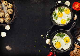 Pans with fried eggs