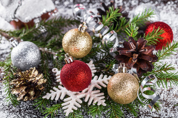 Obraz na płótnie Canvas Christmas or New Year decoration with fir-tree branch, cones, ba
