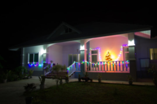 blurred house decorated with lights for Christmas at Night, used for background