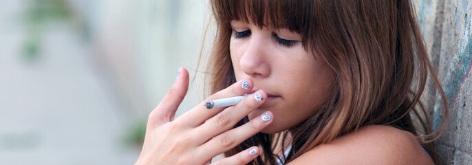 Teenage girl smoking cigarette