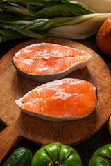 salmon steak on natural marble table with tomatoes cherry , avoc