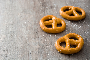 Salted pretzels on wooden background