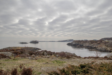 Landscape Scandinavian nature, the rocky shore of the lake, cloudy sky