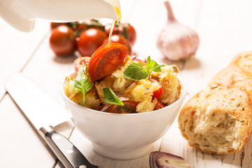 Italian Appetizer salad with tomatoes, bread and bazil