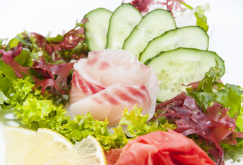 Japanese cuisine sashimi with vegetables and fish in a restaurant