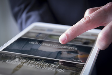 finger touches digital tablet website