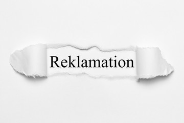 Reklamation on white torn paper
