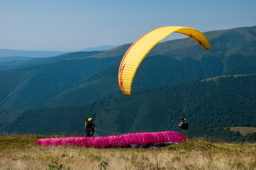 Paraglider, paragliding in the mountains, extreme sports.