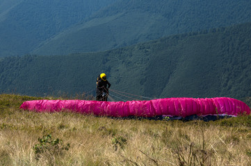 Paraglider, paragliding in the mountains, extreme sports.