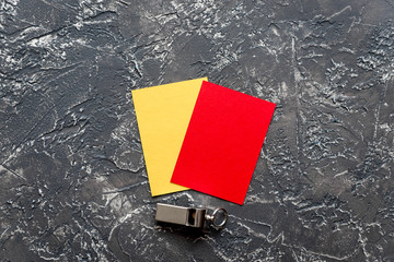 red and yellow cards on dark background top view