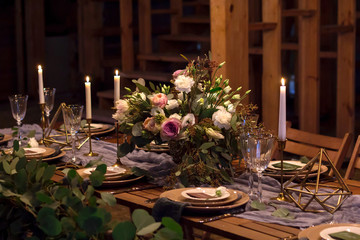 Decoration wedding table before a banquet in a wooden barn.