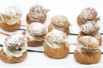 Profiteroles with vanilla ice cream decorated with chocolate mint