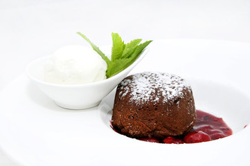 A piece of cream cake decorated with chocolate and mint