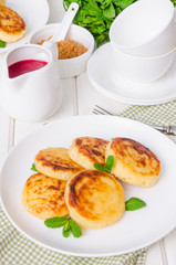 Sweet cottage cheese pancakes and raspberry sauce. Traditional Russian and Ukrainian dish for breakfast.