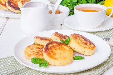 Sweet cottage cheese pancakes and raspberry sauce. Traditional Russian and Ukrainian dish for breakfast.